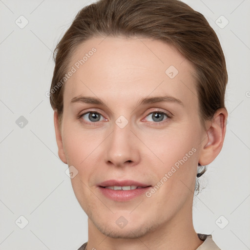 Joyful white young-adult female with short  brown hair and grey eyes