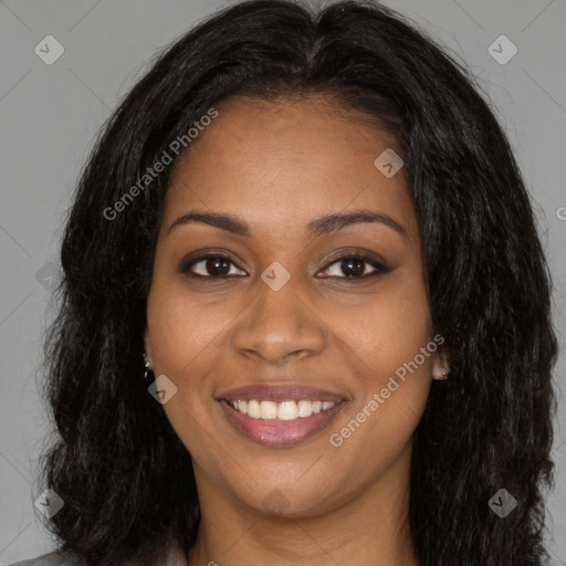 Joyful black young-adult female with long  brown hair and brown eyes