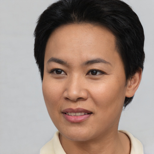 Joyful asian adult female with short  brown hair and brown eyes