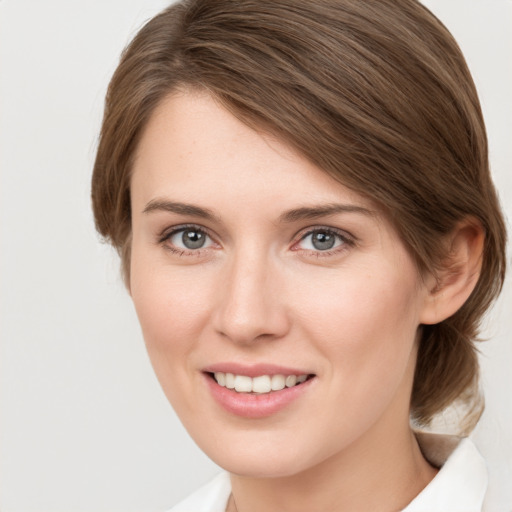 Joyful white young-adult female with medium  brown hair and green eyes