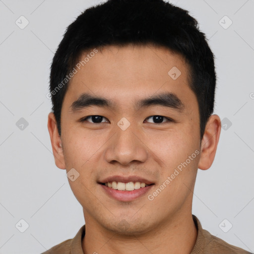 Joyful asian young-adult male with short  black hair and brown eyes