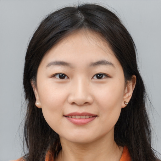 Joyful asian young-adult female with long  brown hair and brown eyes