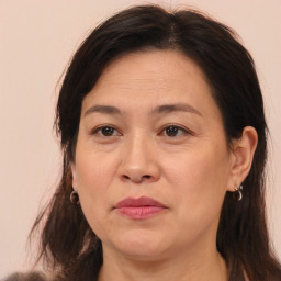 Joyful white adult female with long  brown hair and brown eyes