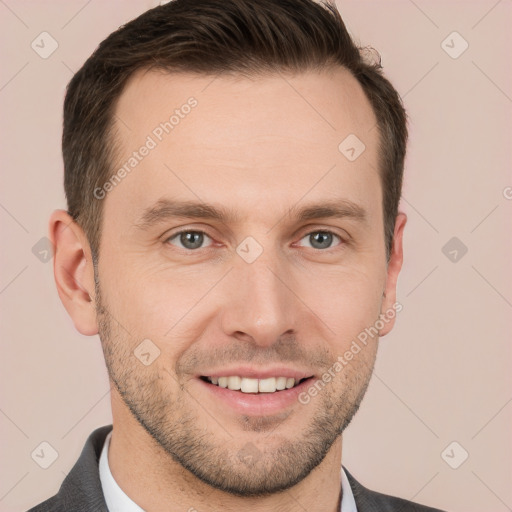 Joyful white young-adult male with short  brown hair and grey eyes