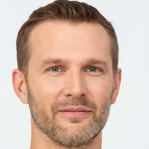 Joyful white adult male with short  brown hair and grey eyes