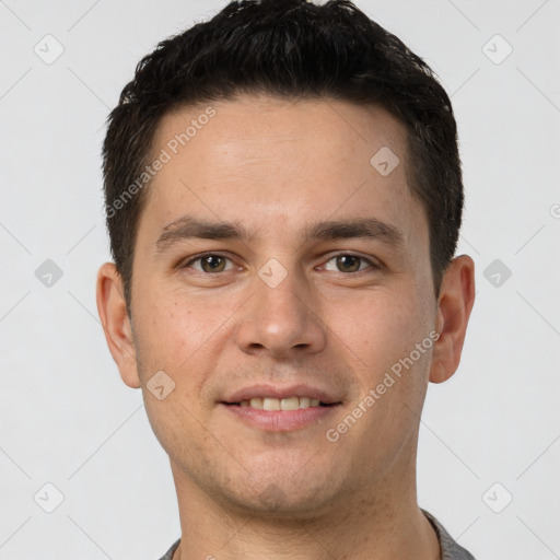 Joyful white young-adult male with short  brown hair and brown eyes