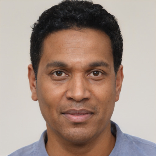 Joyful latino adult male with short  black hair and brown eyes