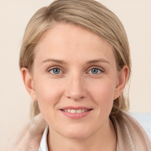 Joyful white young-adult female with medium  brown hair and blue eyes