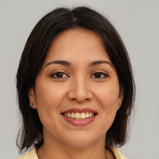 Joyful white young-adult female with medium  brown hair and brown eyes