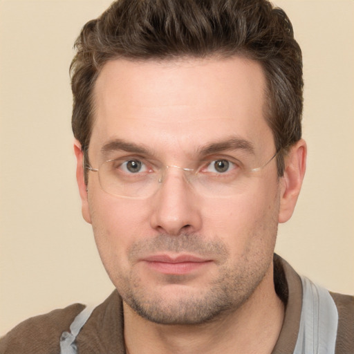 Joyful white adult male with short  brown hair and brown eyes