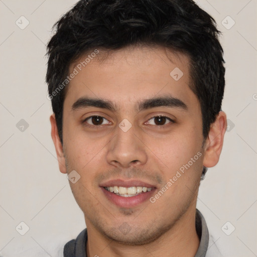 Joyful latino young-adult male with short  brown hair and brown eyes