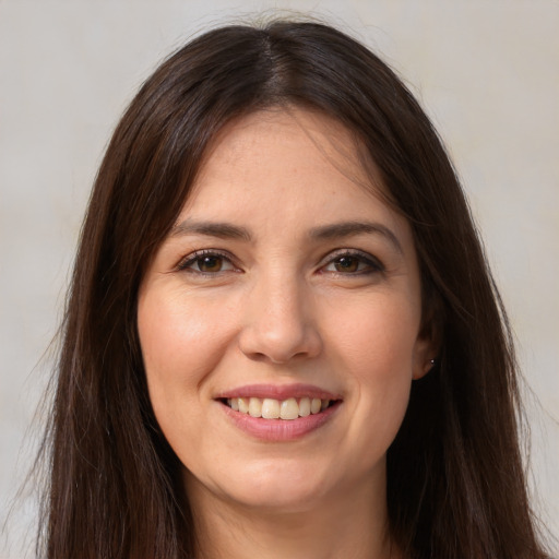 Joyful white young-adult female with long  brown hair and brown eyes