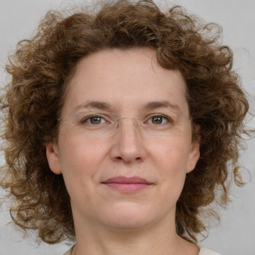 Joyful white adult female with medium  brown hair and green eyes