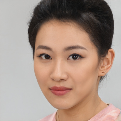 Joyful asian young-adult female with short  brown hair and brown eyes