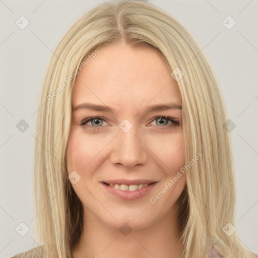 Joyful white young-adult female with long  brown hair and blue eyes