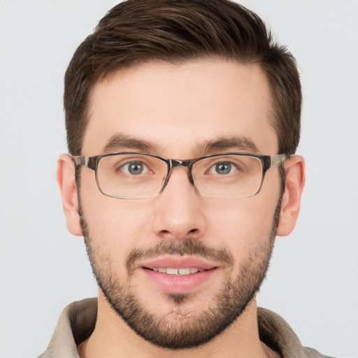 Joyful white young-adult male with short  brown hair and grey eyes