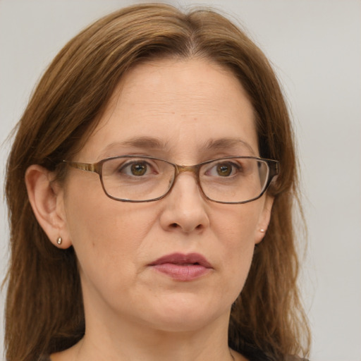 Joyful white adult female with long  brown hair and green eyes