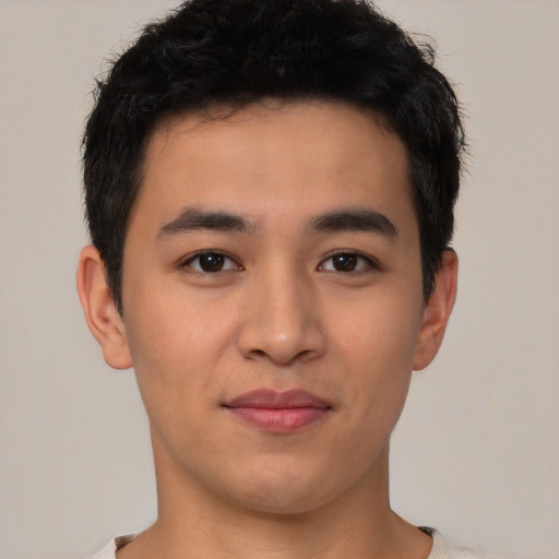 Joyful asian young-adult male with short  black hair and brown eyes