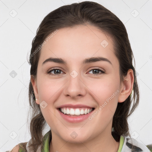 Joyful white young-adult female with medium  brown hair and grey eyes