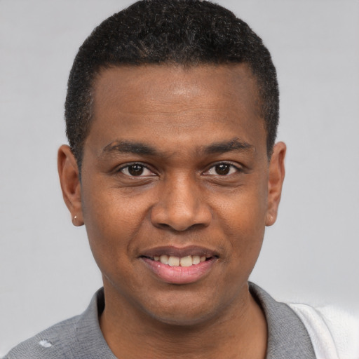 Joyful black young-adult male with short  brown hair and brown eyes