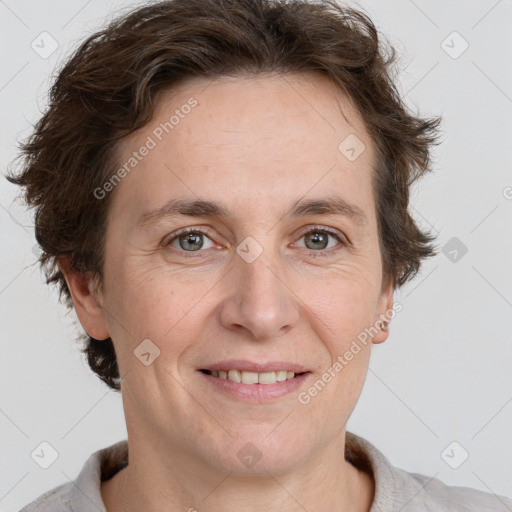 Joyful white adult female with short  brown hair and grey eyes