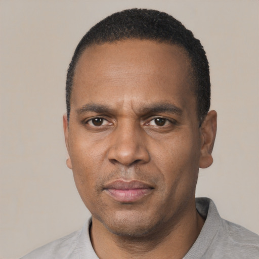 Neutral black adult male with short  black hair and brown eyes