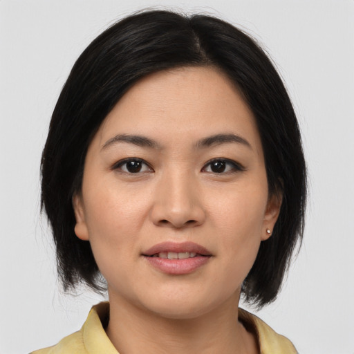 Joyful asian young-adult female with medium  brown hair and brown eyes