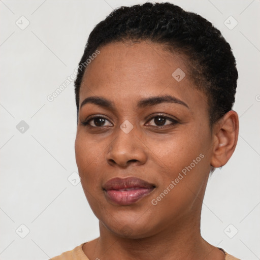 Joyful black young-adult female with short  black hair and brown eyes