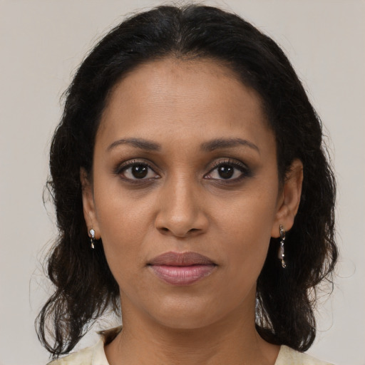 Joyful black young-adult female with medium  brown hair and brown eyes