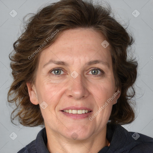 Joyful white adult female with medium  brown hair and blue eyes