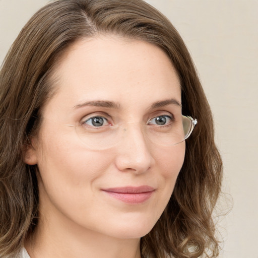 Joyful white young-adult female with medium  brown hair and green eyes