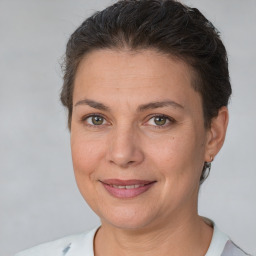 Joyful white adult female with short  brown hair and brown eyes