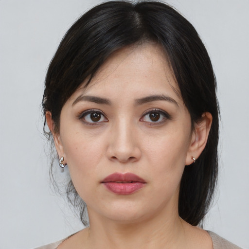 Joyful asian young-adult female with medium  brown hair and brown eyes
