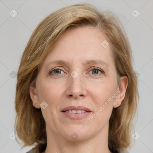 Joyful white adult female with medium  brown hair and blue eyes