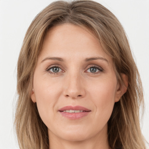 Joyful white adult female with long  brown hair and brown eyes