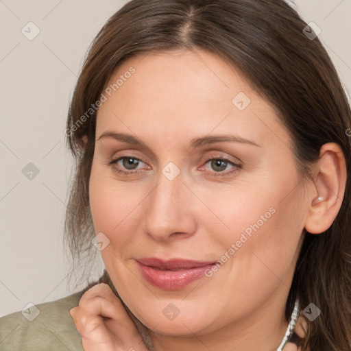 Joyful white adult female with medium  brown hair and grey eyes