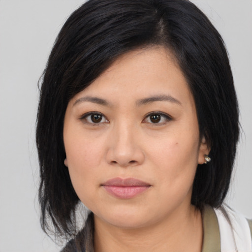 Joyful asian young-adult female with medium  black hair and brown eyes