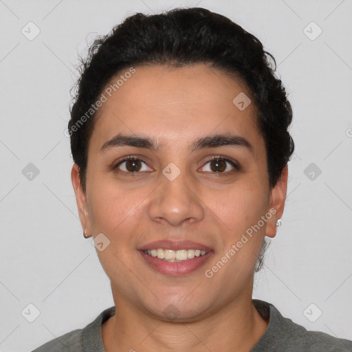 Joyful latino young-adult female with short  black hair and brown eyes