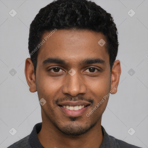 Joyful black young-adult male with short  black hair and brown eyes