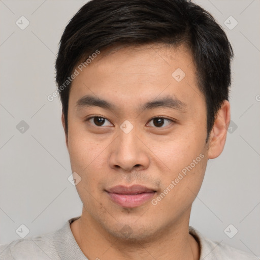 Joyful asian young-adult male with short  brown hair and brown eyes