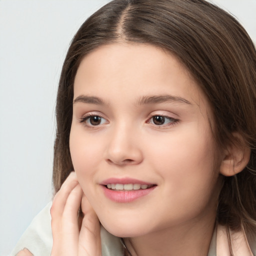 Joyful white child female with long  brown hair and brown eyes