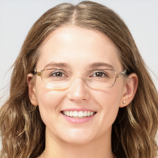 Joyful white adult female with long  brown hair and blue eyes