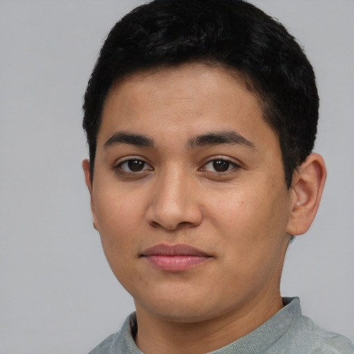 Joyful latino young-adult male with short  black hair and brown eyes