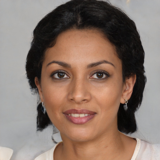 Joyful latino young-adult female with medium  black hair and brown eyes