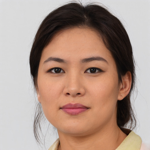 Joyful asian young-adult female with medium  brown hair and brown eyes