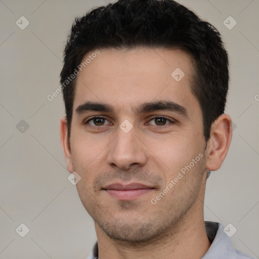 Joyful white young-adult male with short  black hair and brown eyes