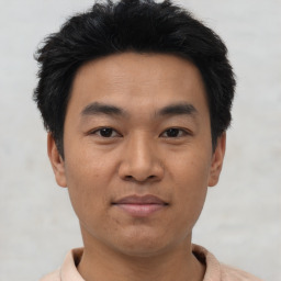 Joyful asian young-adult male with short  black hair and brown eyes