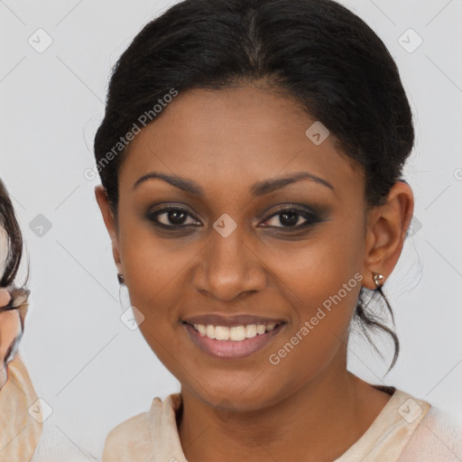 Joyful black young-adult female with medium  brown hair and brown eyes