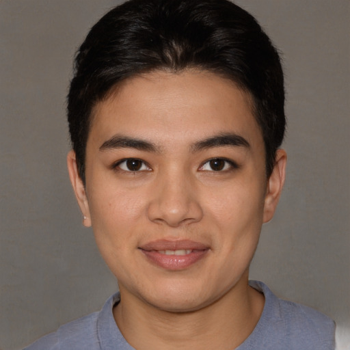 Joyful asian young-adult male with short  brown hair and brown eyes