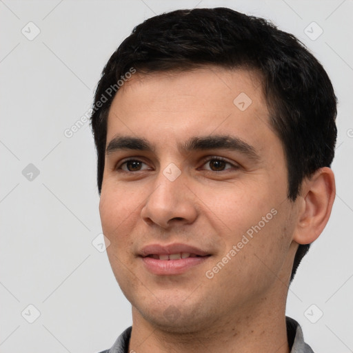 Joyful white young-adult male with short  black hair and brown eyes